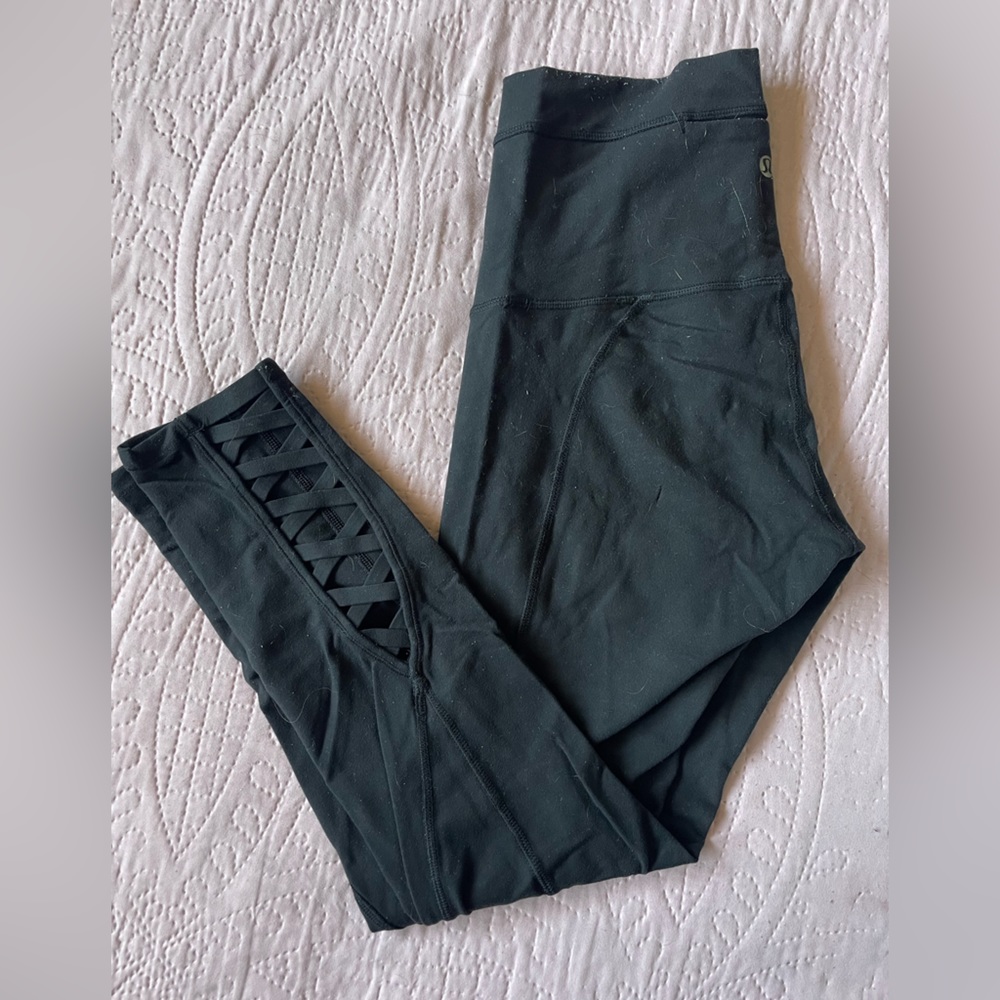 Black Lululemon leggings with criss-cross on the back of the legs